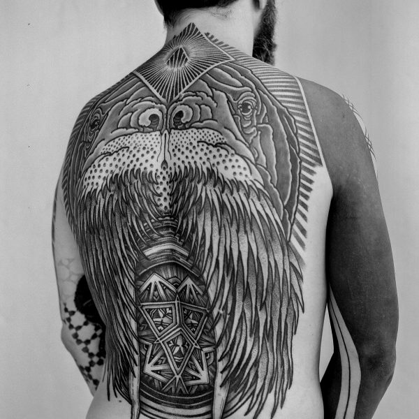 Complex blackwork tattoo by Thomas Hooper, featuring intricate geometric patterns and layered textures. Known for his abstract, meditative style, Thomas creates tattoos that blend organic and cosmic forms with precise linework and deep visual rhythm.