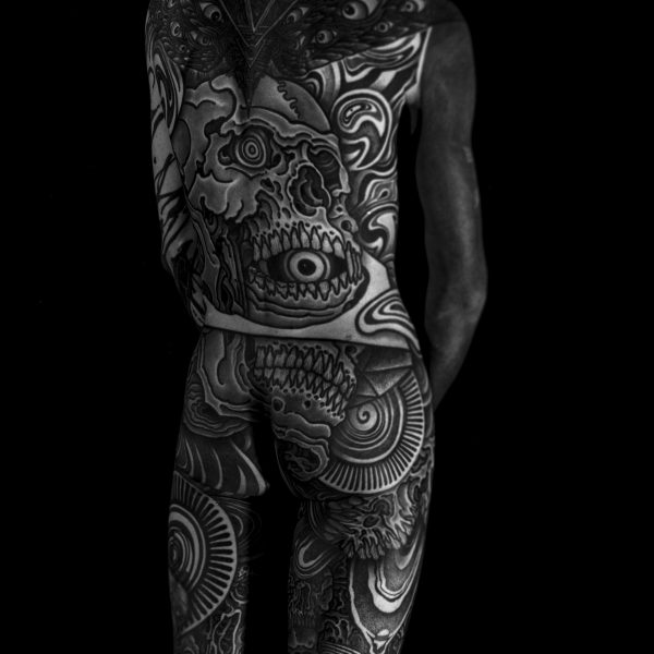 Complex blackwork tattoo by Thomas Hooper, featuring intricate geometric patterns and layered textures. Known for his abstract, meditative style, Thomas creates tattoos that blend organic and cosmic forms with precise linework and deep visual rhythm.