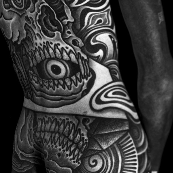 Complex blackwork tattoo by Thomas Hooper, featuring intricate geometric patterns and layered textures. Known for his abstract, meditative style, Thomas creates tattoos that blend organic and cosmic forms with precise linework and deep visual rhythm.