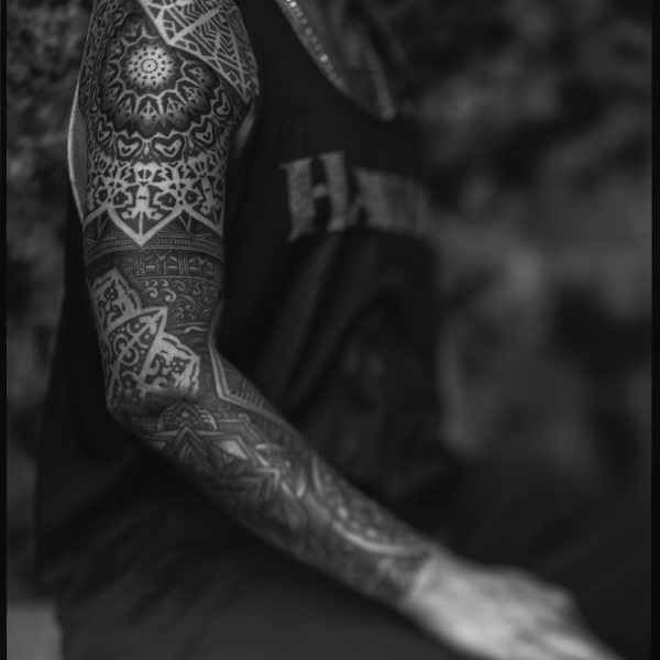 Complex blackwork tattoo by Thomas Hooper, featuring intricate geometric patterns and layered textures. Known for his abstract, meditative style, Thomas creates tattoos that blend organic and cosmic forms with precise linework and deep visual rhythm.