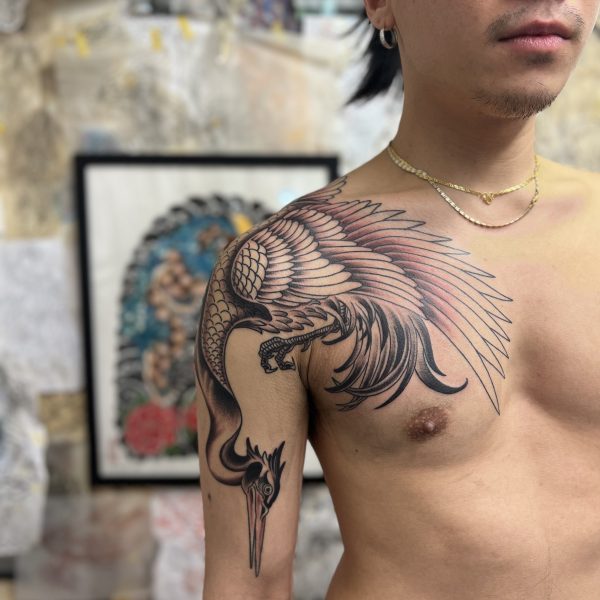 Freehand crane, wrapping around the shoulder and chest for an ornamental and graphic look. The work is featured on fashion designer Chet Lo and was tattooed by Sussex and Brighton based Tattoo Artist, Antony Dickinson