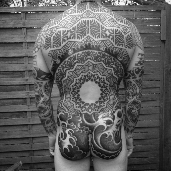 A geometric back piece with wave detailing by Jim Macairt. Jim is a veteran within tattooing with over 35 years experience. Previously owning Good Karma Tattoo Studio in Eastbourne, Jim now bases himself at Nowhere Tattoo Studio in Brighton.