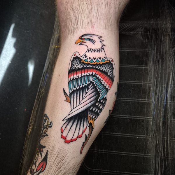 Traditional style eagle tattoo by Edoardo Cucchelli. With over ten years experience tattooing, Edoardos practice is focused within the European traditional style, creating bright, bold, colorful tattoos for his clientele.