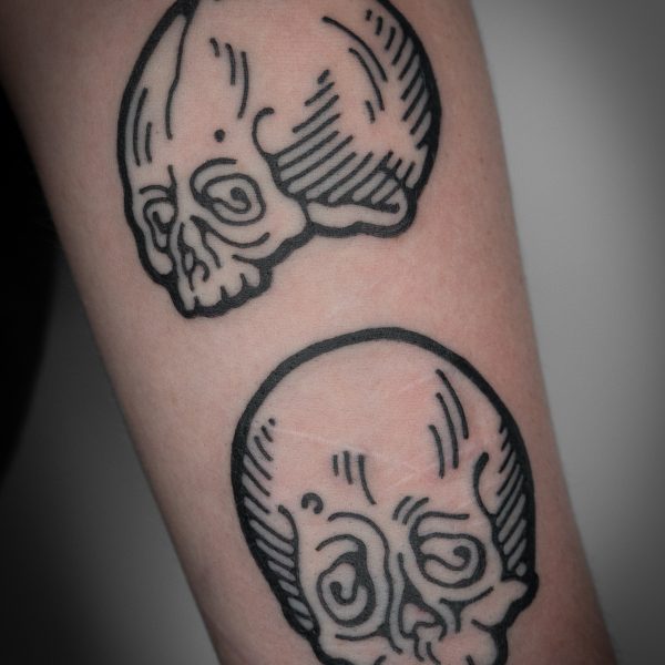 A pair of intricate, woodcut style skull tattoos by Mouse. Mouse is a tattoo artist who has developed a unique style which stands out amongst contemporary tattoo artists, by creating thick, bold tattoos which mimic line work from woodcarvings and etchings. Mouse works between London, and Brighton, UK.