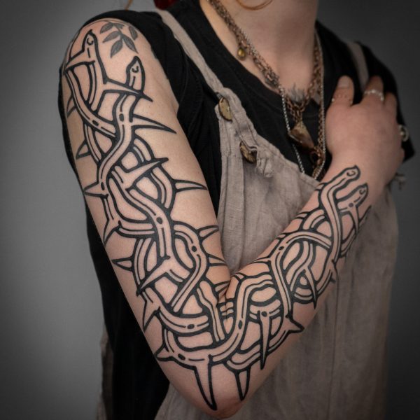 Thorn tattoo sleeve, by Mouse. Mouse is a tattoo artist who works between both Brighton, and London, UK. He creates pieces that are bold, intricate, and clean. Inspired by folk tales, fantasy stories, and etchings. He mimics the carvings from a woodcut print, using a tattoo machine, creating beautifully unique tattoos.