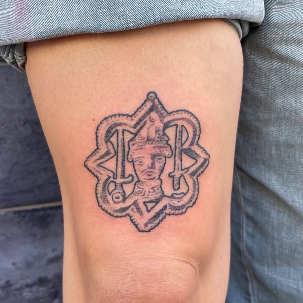 Handpoke tattoo by Rhianna I’Anson, featuring detailed, textural linework inspired by artefacts, stonework, and folklore. Rhianna works from Nowhere Tattooing in Brighton, blending traditional techniques with a timeless, organic style