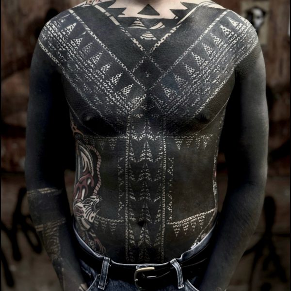 Bold blackwork tattoo by Francesco Capro, featuring strong ornamental patterns and timeless design. Francesco, originally from Northern Italy, works from Nowhere Tattooing in Brighton and Seven Doors Tattoo in London, bringing over thirteen years of experience and a passion for powerful, culturally rich tattoo art.